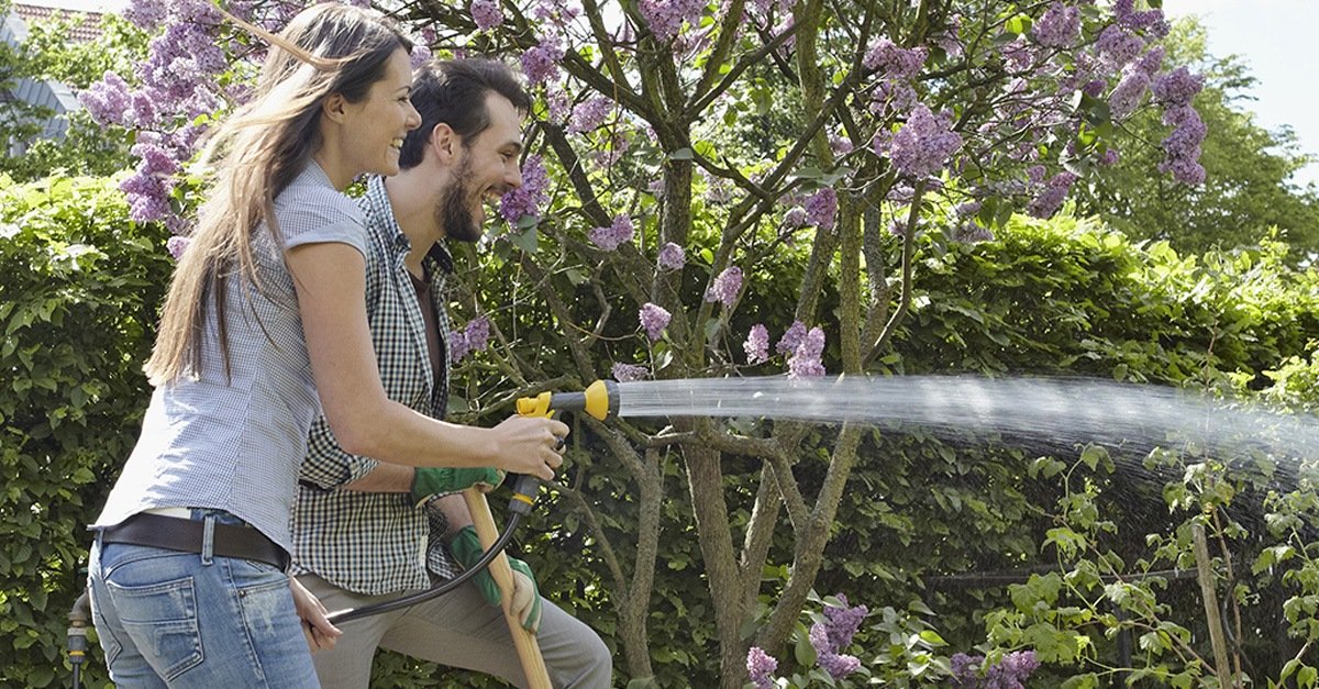 AXA fair Finanzpartner oHG Bremen Pärchen im Garten mit Wasserschlauch